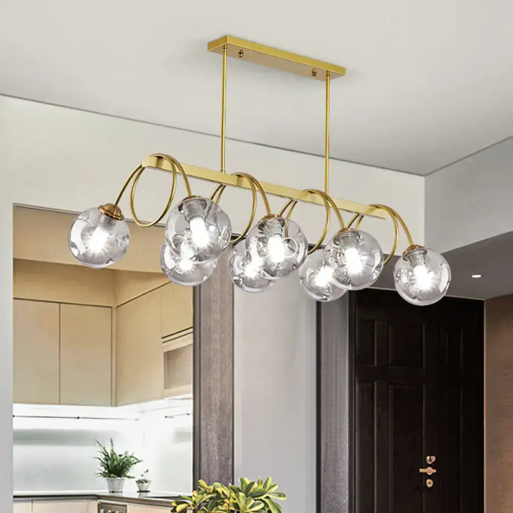 DecorBites™ sleek gold spiral island light with gold finish metal arms and clear glass globe bulbs for modern ceiling decor