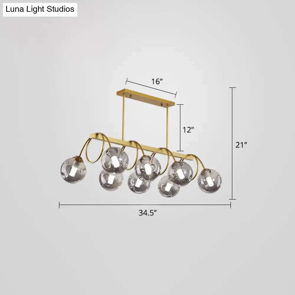 Decorbites™ sleek gold finish spiral island light with seven clear glass globe bulbs and post-modern metal design