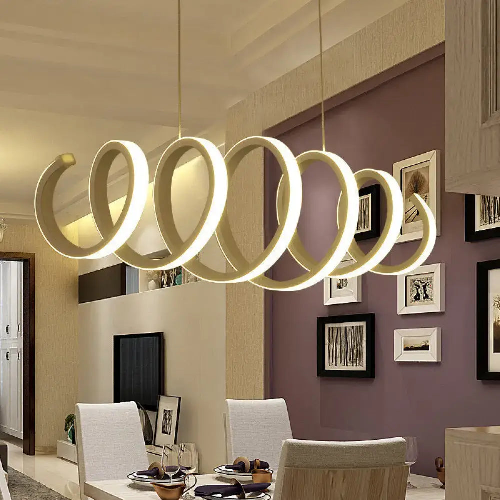Modern cream-colored pendant light minimalistic metal with sleek interconnected ring design providing warm white light