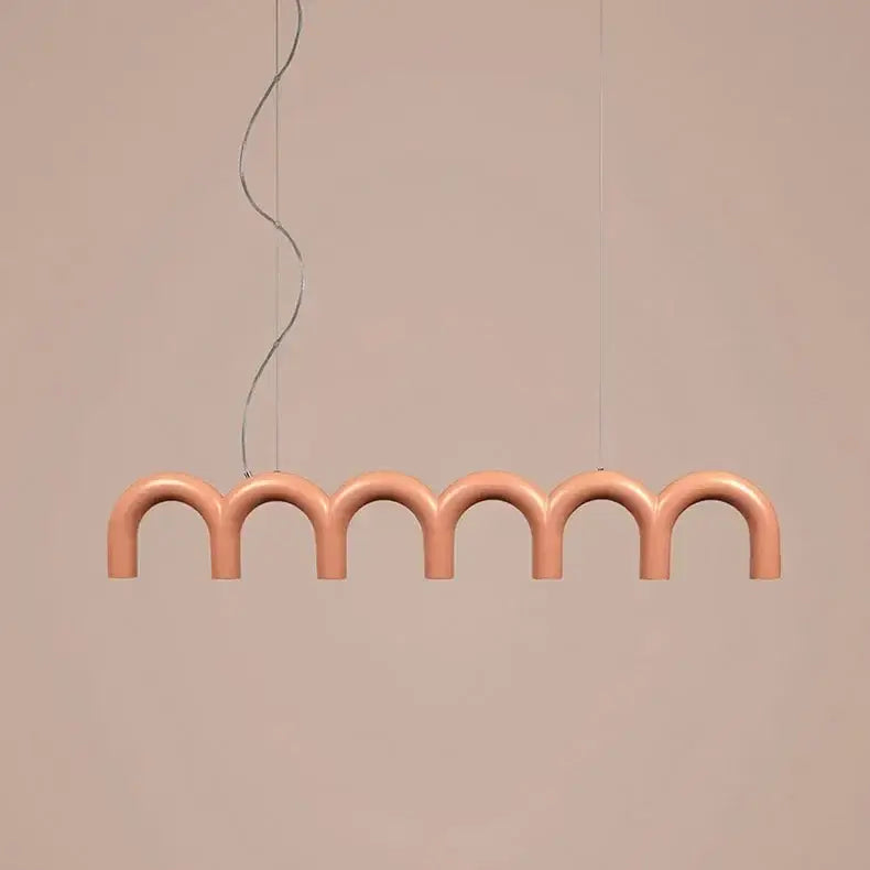 A modern peach-colored DecorBites™ sleek u-shaped chandelier with curved arches for bedroom and kitchen lighting