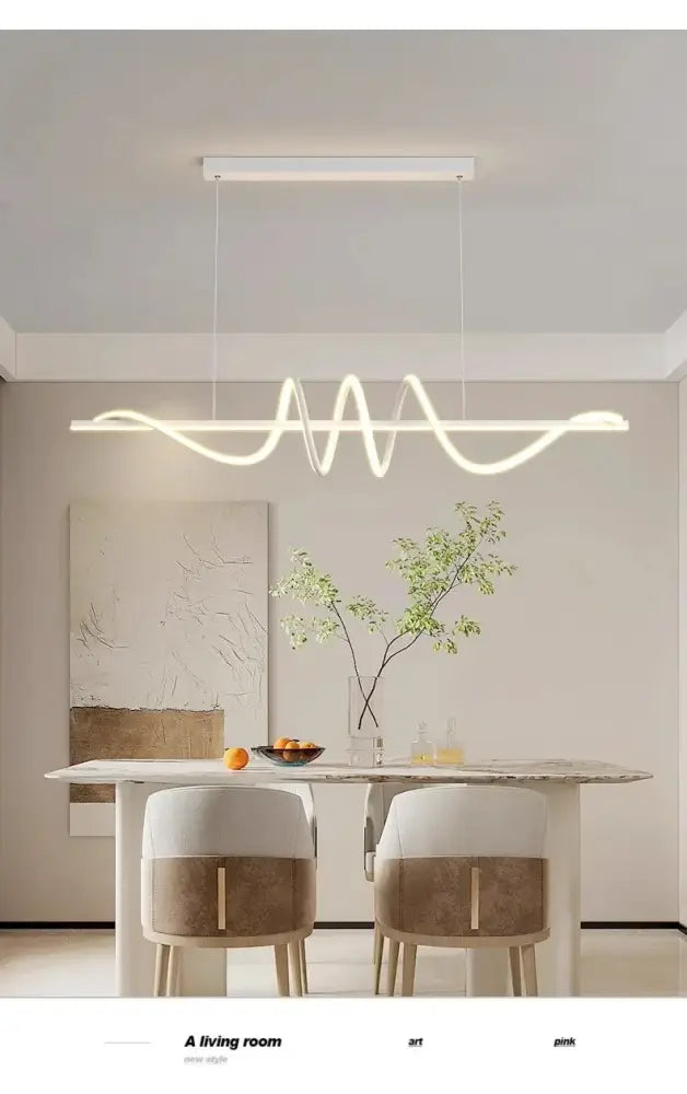 Modern white led pendant lights with sleek wavy design hanging above dining room table by DecorBites