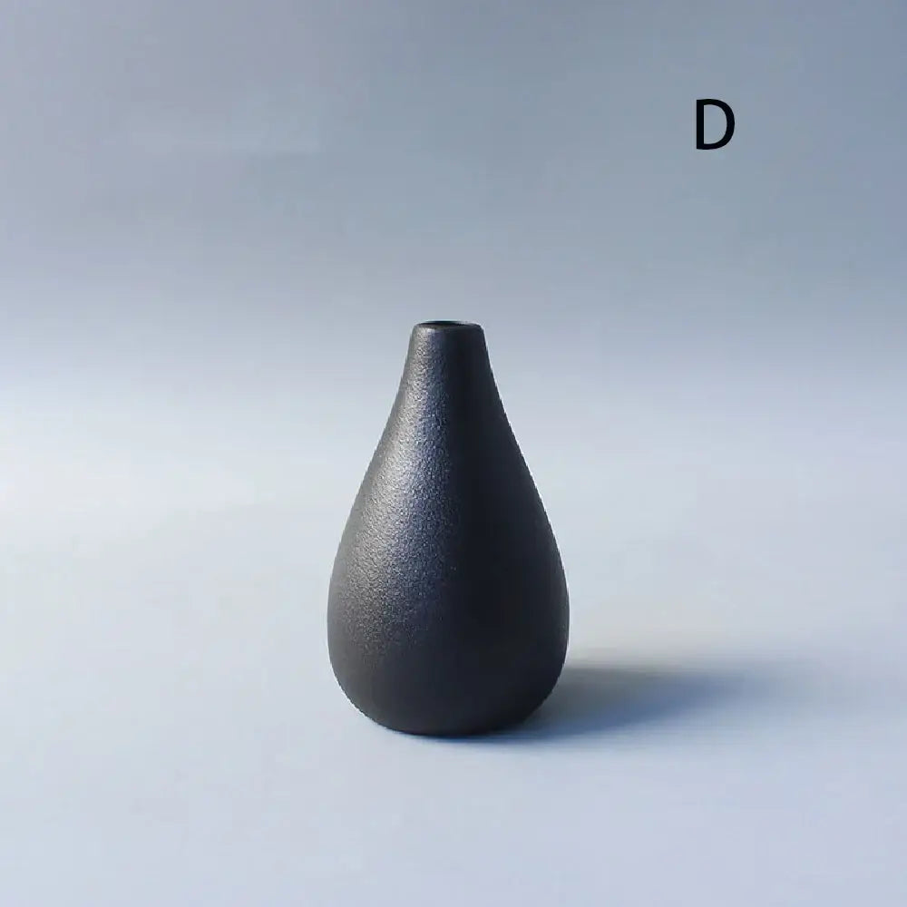 A sleek matte black ceramic small vase with a teardrop shape perfect for elegant japanese home decor
