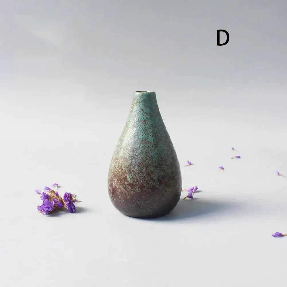 A teardrop-shaped ceramic small vase with mottled green and brown glaze for elegant Japanese home decor