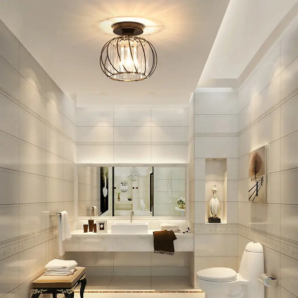 DecorBites™ small metal cage ceiling light fixture with dark metal and clear crystal prisms above bathroom vanity
