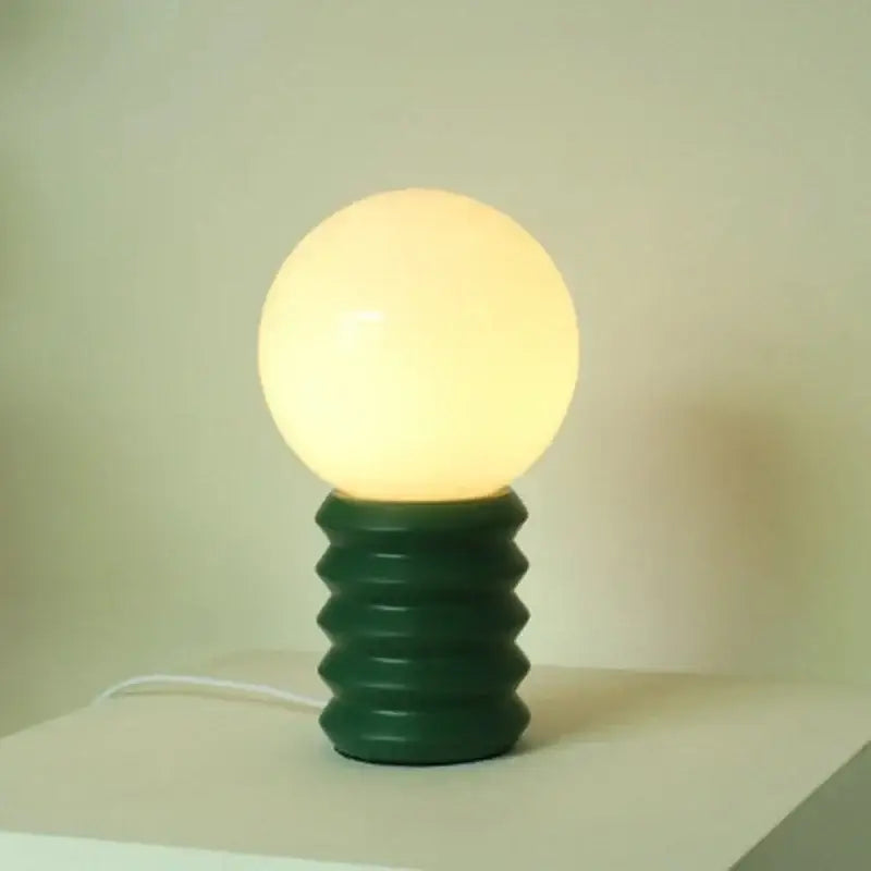 DecorBites™ small table lamp bauhaus with warm glowing spherical lamp and dark green ribbed base for small table use