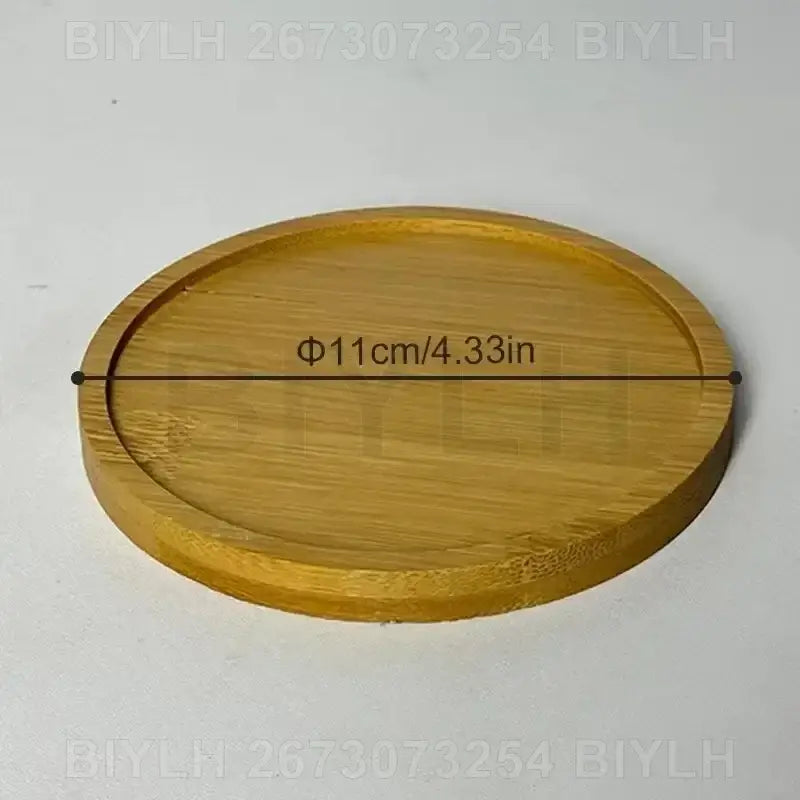 Decorbites™ small transparent glass vase displayed on a round light brown bamboo coaster with natural wood grain pattern
