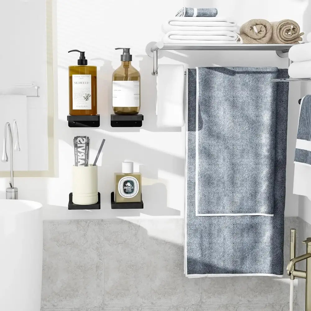 A dark gray textured towel with white border hanging on a metal rack below decorbites™ small floating shelves 4-pack