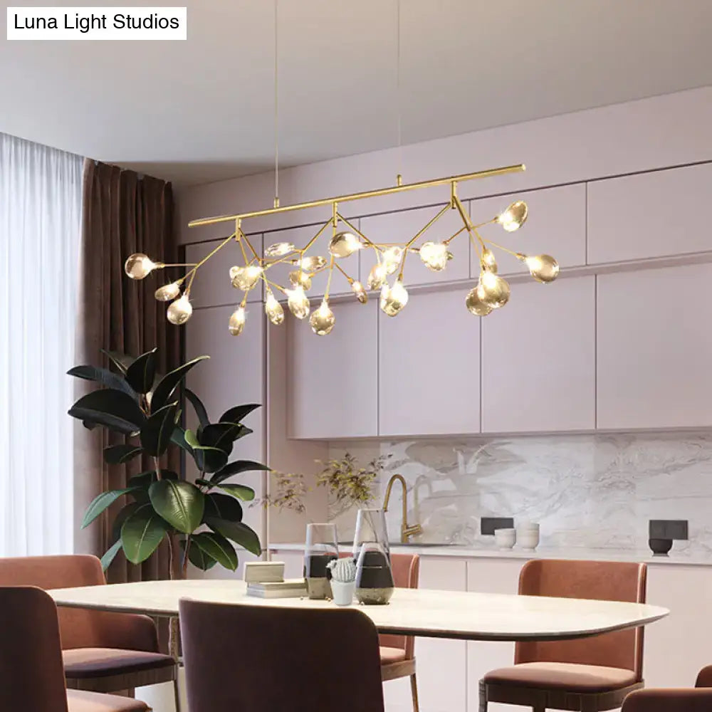 Gold-toned modern chandelier with branching arms and clear globe shades for smoke grey glass firefly island lighting