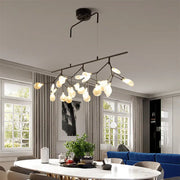 Black metal chandelier with smoke grey glass firefly frosted bulbs in a branching tree-like design for dining room lighting