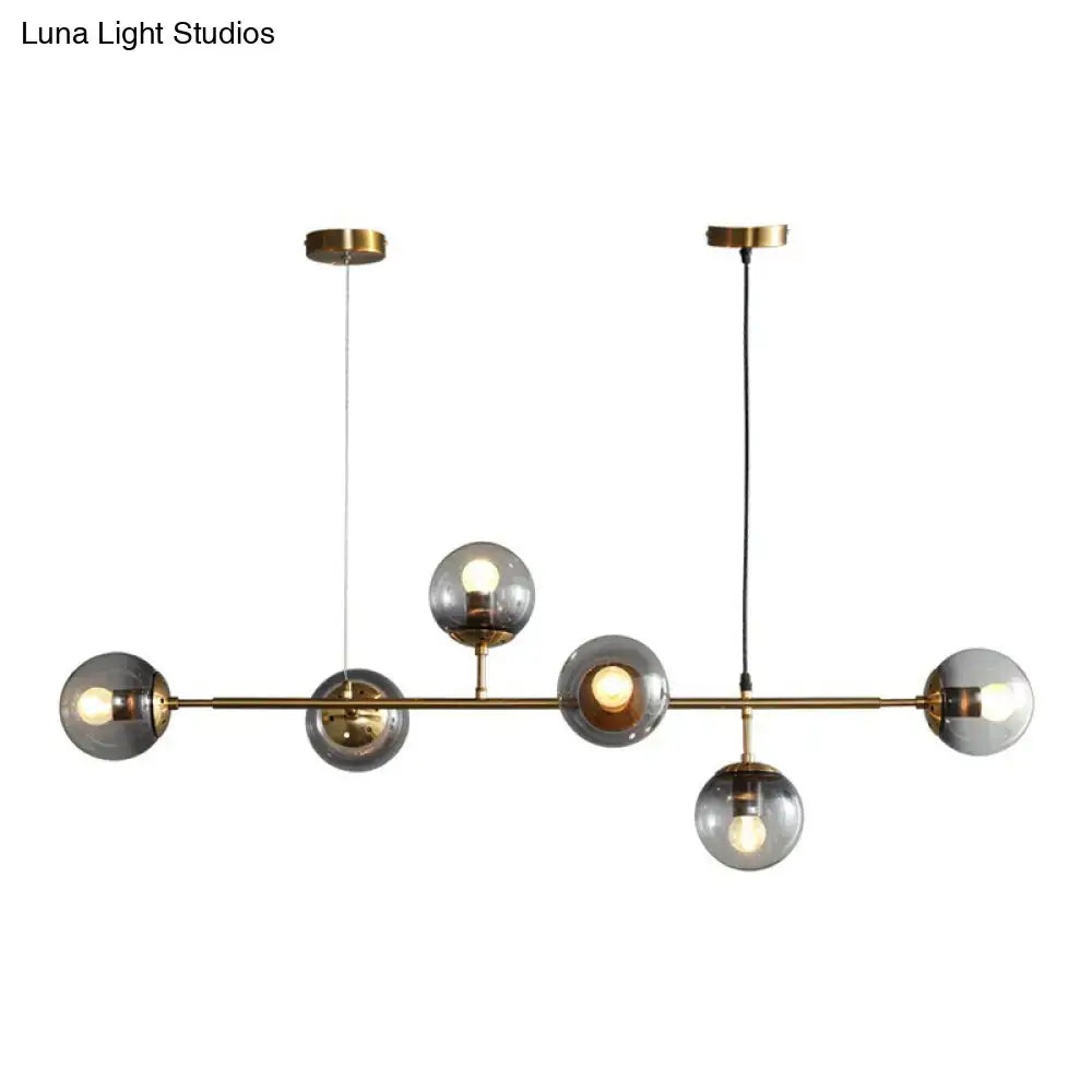 Decorbites™ smoke grey glass island pendant light with six smoke grey globes and brass finish ideal for restaurants