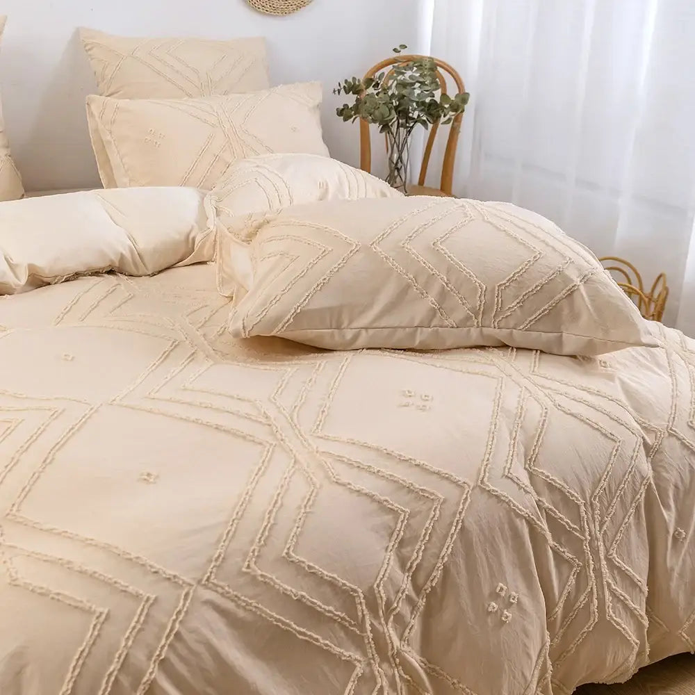 Cream-colored microfiber duvet cover set with geometric embroidery and frayed edge detailing by decorbites