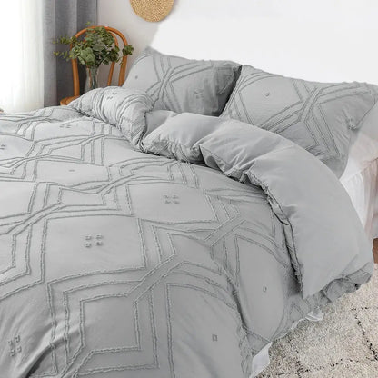Gray quilted duvet cover set with geometric embroidery and ruffled edges made of soft tufted microfiber by decorbites