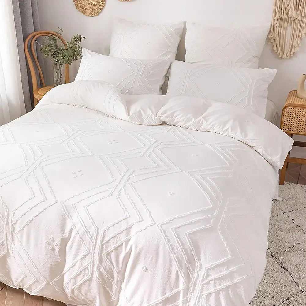 White quilted duvet cover set with geometric embroidery pattern made of soft tufted microfiber by DecorBites