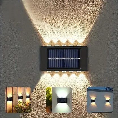 Black rectangular decorbites™ solar led outdoor wall light with multiple led bulbs emitting warm white illumination