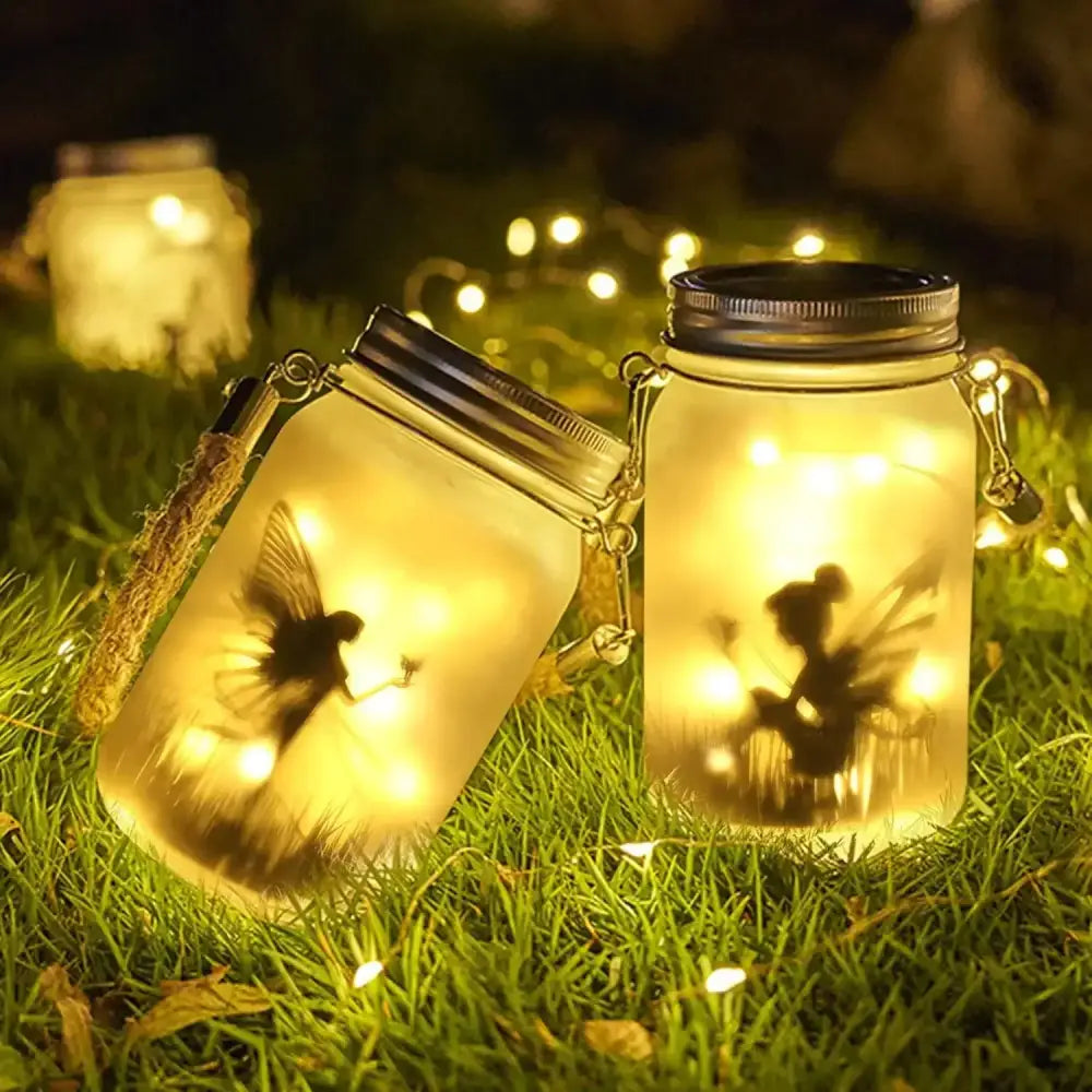 Glass mason jar solar lanterns with fairy silhouettes and warm yellow led lights for garden decoration by decorbites