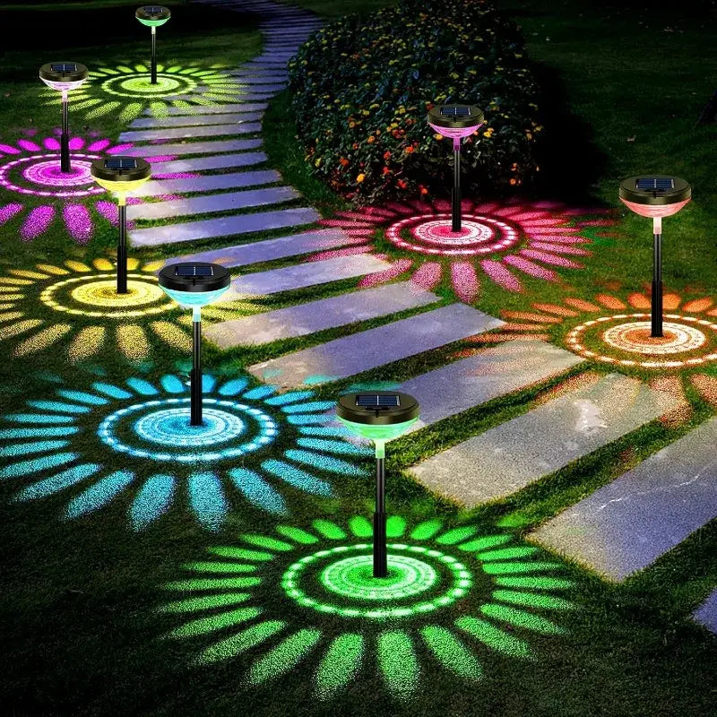 Decorbites™ solar pathway lights 6 pack with color changing and warm white led projecting flower shapes on grass