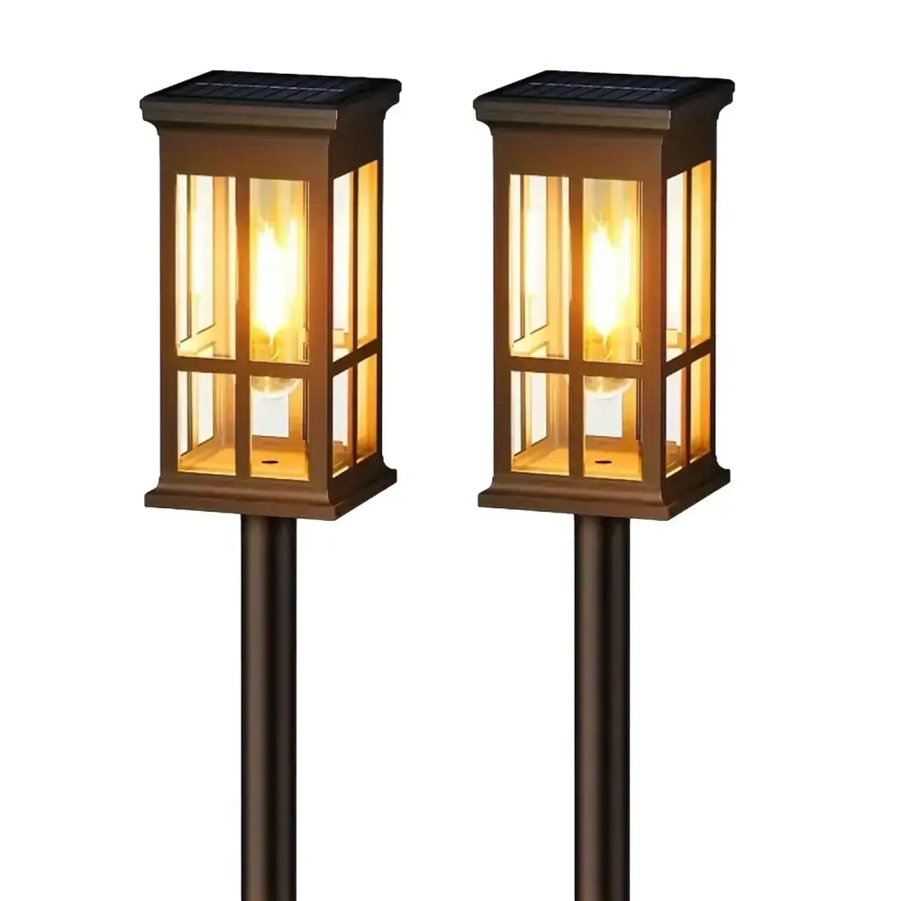 Pair of bronze-finished decorbites solar pathway lights with clear glass panels and warm yellow led illumination