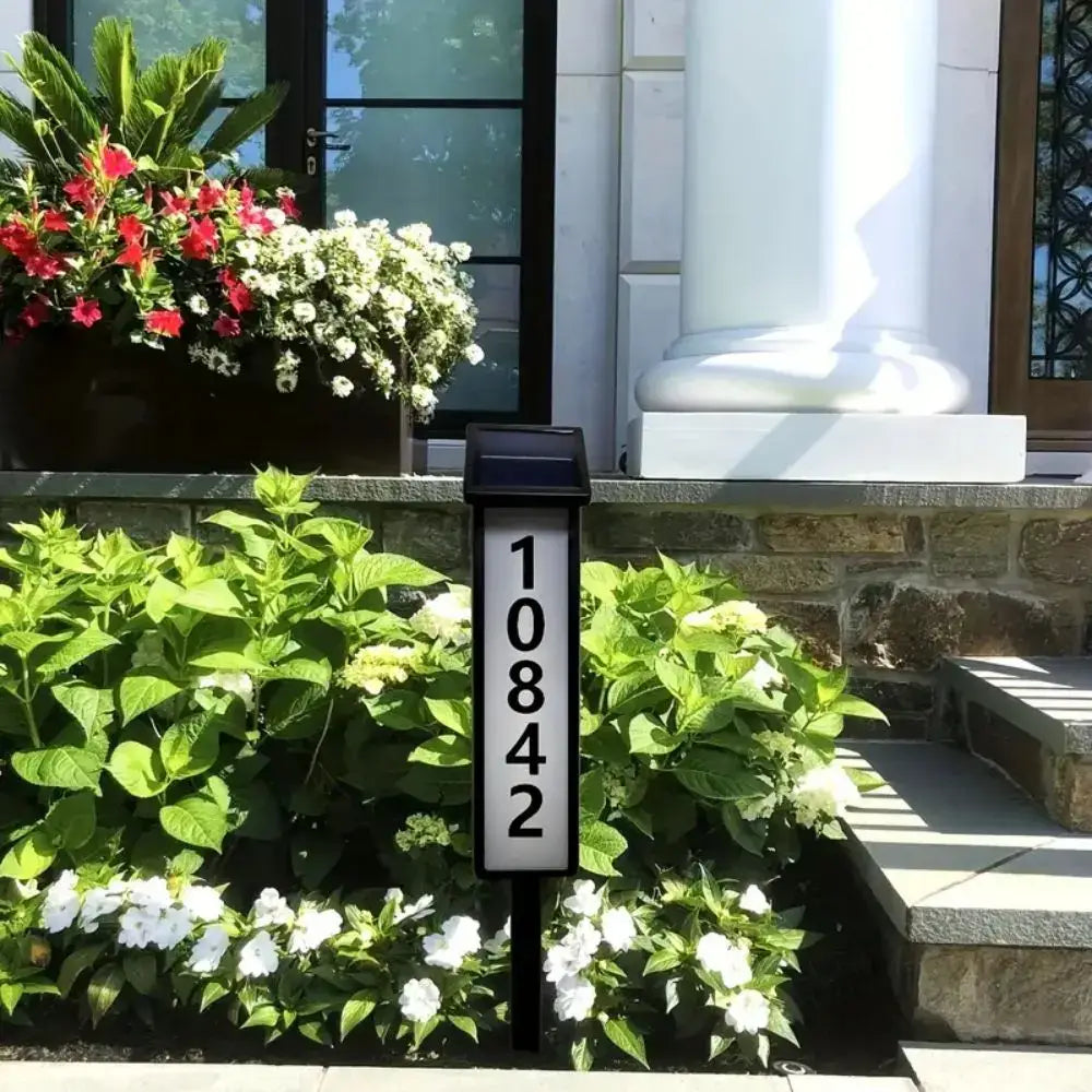 Black solar powered led house number light by decorbites with white numerals 10842 and modern sleek design