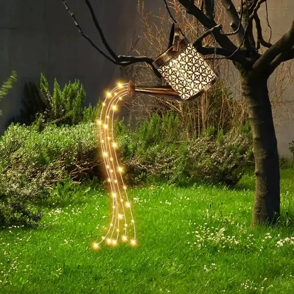 Decorbites™ solar watering can light in metal with geometric cutouts emitting warm glow for outdoor space decor