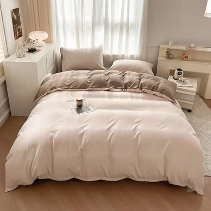 Beige satin-like solid color brush fabric duvet cover set with matching pillowcases neatly arranged on bed