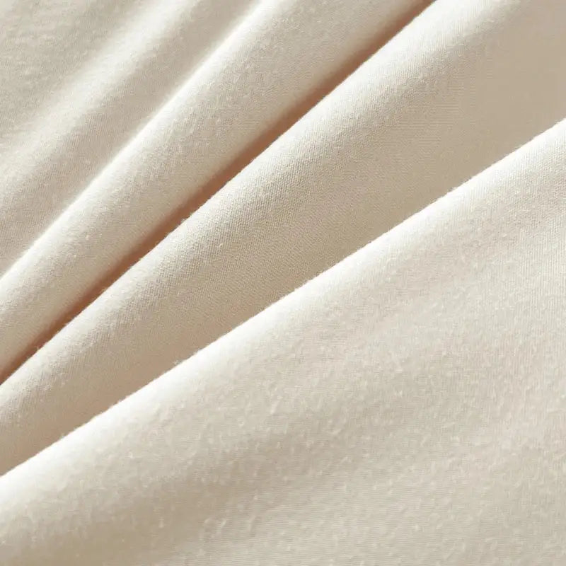 Cream-colored solid color brush fabric duvet cover with subtle sheen and soft texture from decorbites bedding set