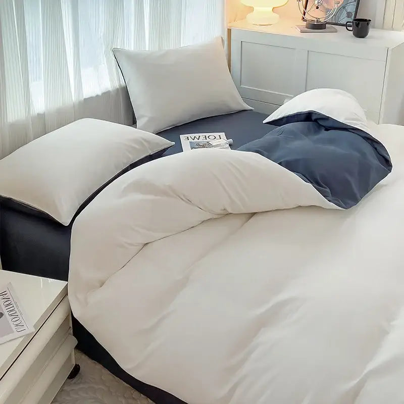 Cream-colored and navy blue two-tone quilted duvet cover set in solid color brush fabric with soft cotton finish from DecorBites™