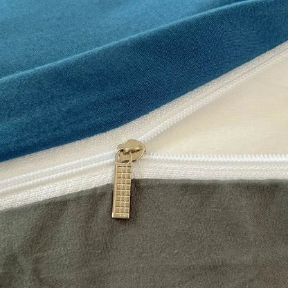 Gold-toned zipper pull with textured grid on solid color blue brush fabric duvet cover from DecorBites bedding set