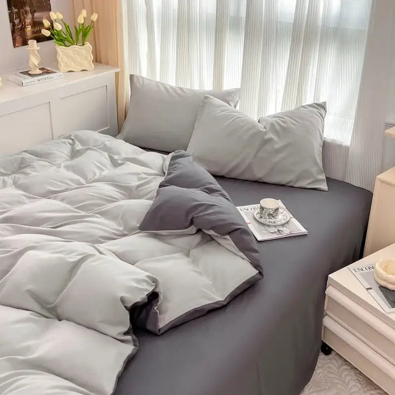 Gray quilted duvet cover set with matching pillowcases in solid color brush fabric featuring subtle stitching details