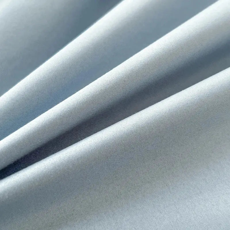 Light blue solid color brush fabric duvet cover with smooth texture and subtle diagonal weave in 4 piece bedding set