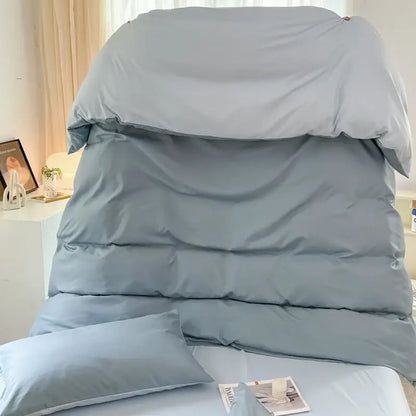 Light blue solid color quilted duvet cover and pillowcases made of brush fabric in a DecorBites™ 4-piece set