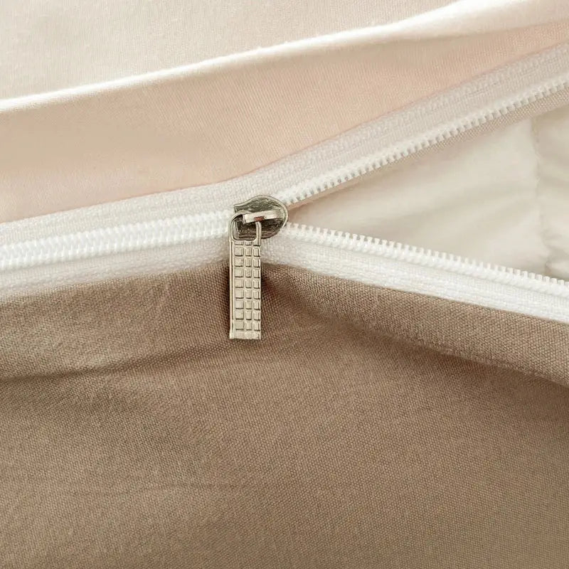 Silver-toned zipper pull with textured grid pattern on decorbites solid color brush fabric duvet cover set