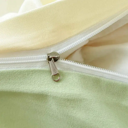 Silver-toned zipper pull with textured grip on decorbites™ solid color brush fabric duvet cover set in light green and cream