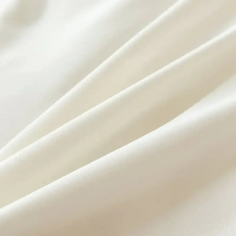 Soft creamy white solid color brush fabric duvet cover with smooth glossy texture and gentle folds from decorbites bedding set