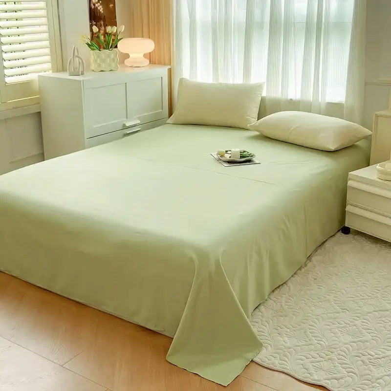 A soft mint green solid color duvet cover made of brush fabric neatly drapes over the mattress in the decorbites bedding set