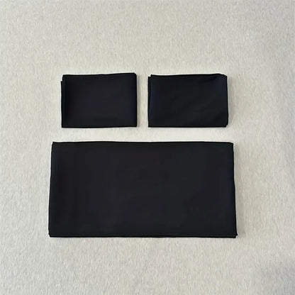 Set of three black folded fabric napkins complementing the DecorBites™ solid color brushed duvet cover set