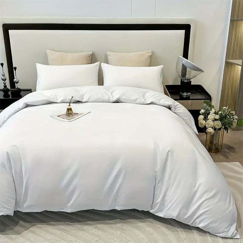 White satin decorbites™ solid color brushed duvet cover set with matching pillowcases neatly arranged on bed