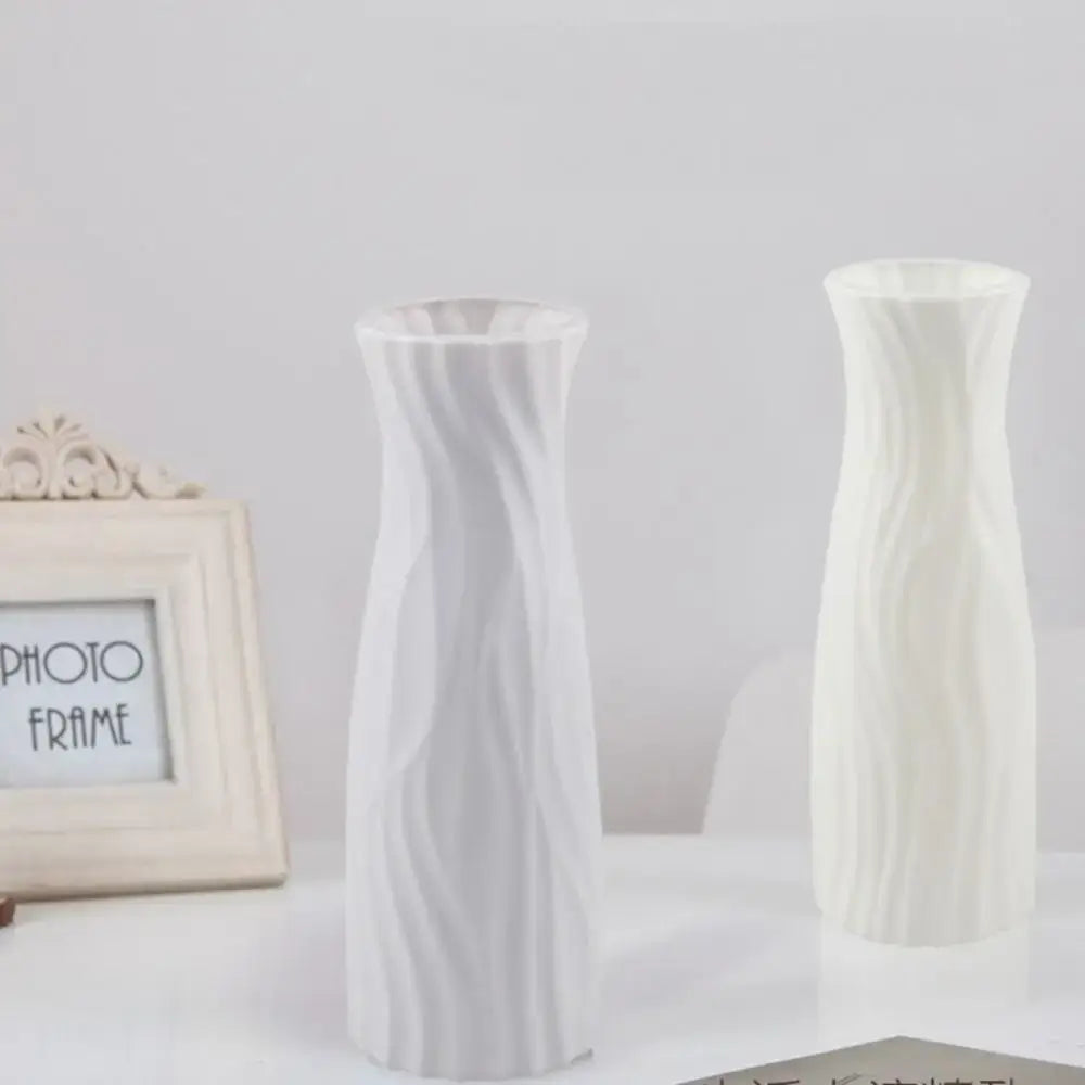 Two elegant solid color white plastic flower vases with swirling ribbed texture for home decor by DecorBites