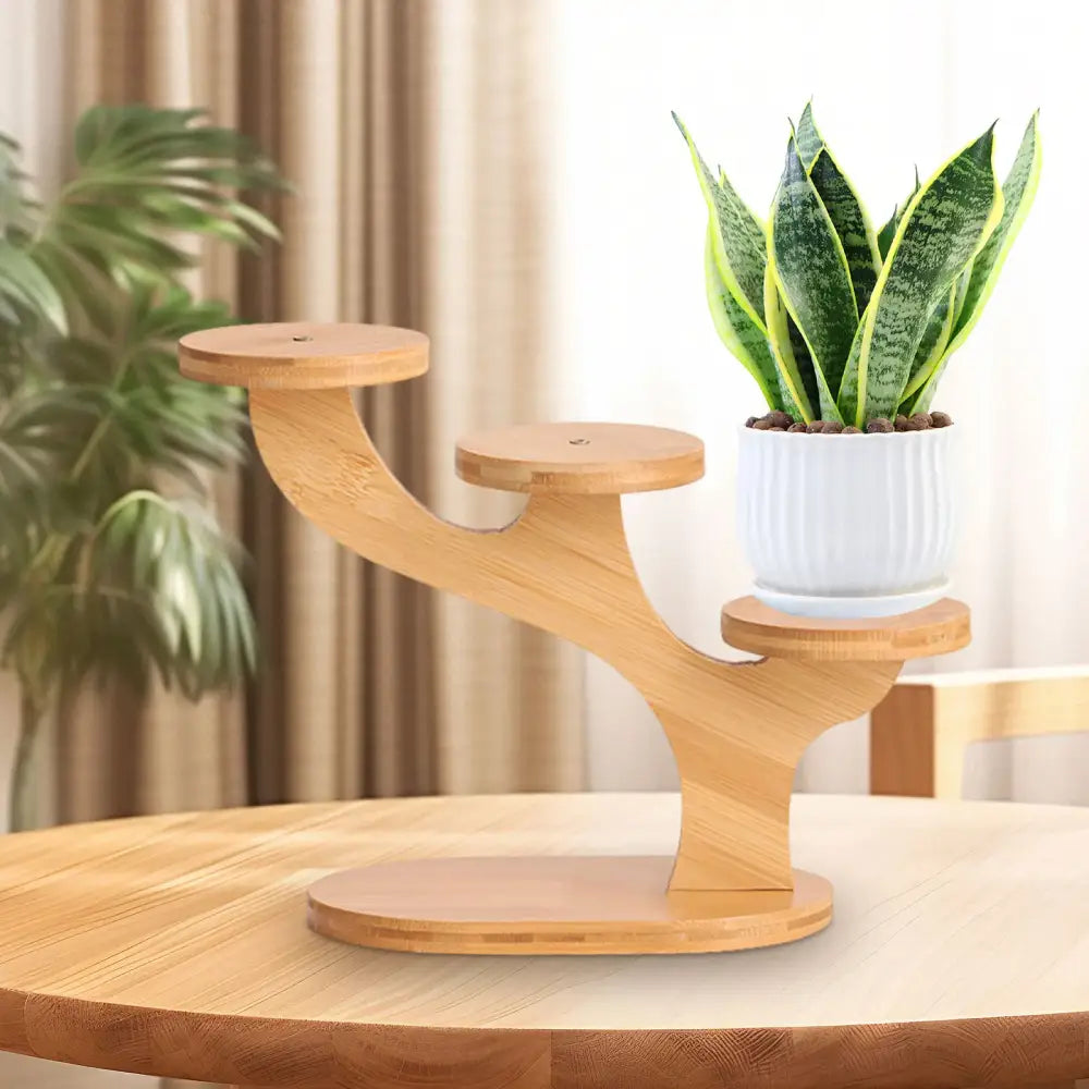 Light brown bamboo DecorBites™ flower pot stand with three tiered circular platforms holding a white ribbed pot