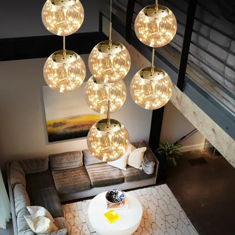 Gold-toned crystal ball chandelier with intricate wireframe and warm glowing fairy lights by DecorBites™