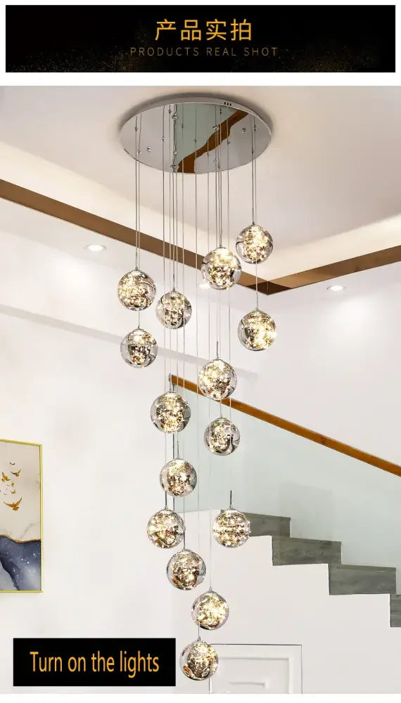 A modern DecorBites spiral crystal ball chandelier light with multiple reflective metallic glass orbs hanging in a circle