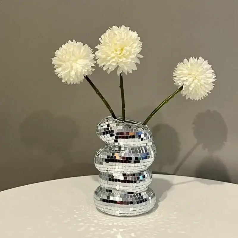 DecorBites™ spiral vase with a reflective mosaic plastic spiral design holds three fluffy white creative flowers