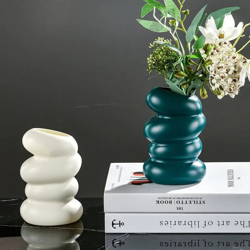 Teal ceramic vase with a stacked rounded bumpy design resembling a spiral white vase for home decoration