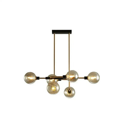 Modern brass and black sputnik hanging island light with six amber glass bulbs for dining room decor by DecorBites™