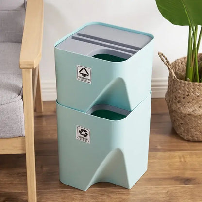Stacked mint green plastic decorbites stackable trash bins with gray lids and internal compartments for kitchen recycling