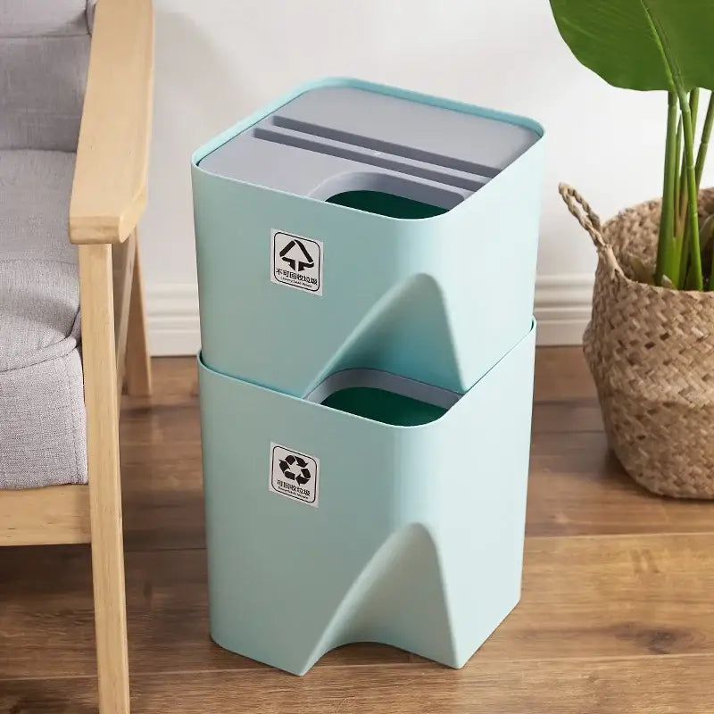 Stacked mint green plastic decorbites stackable trash bins with gray lids and internal compartments for kitchen recycling
