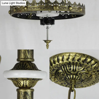 Antique brass ornate ceiling chandelier with intricate filigree and white ceramic ring for indoor kitchen lighting