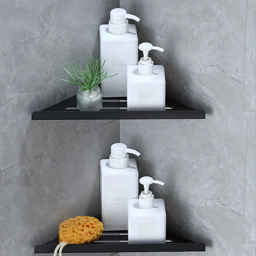 Decorbites™ stainless steel black triangular corner shower shelf with matte finish holding white pump bottles and decor items