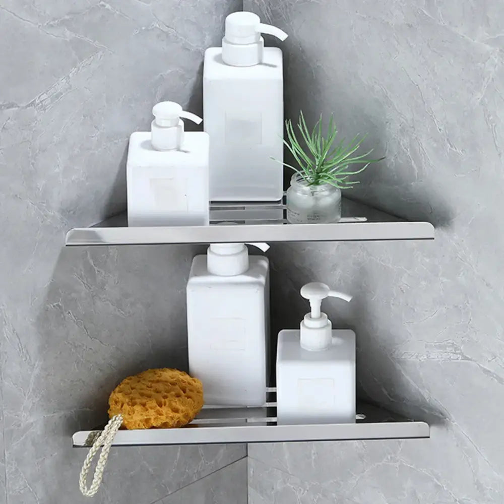 Decorbites stainless steel silver triangular corner shower shelf with two tiers holding bottles and plant