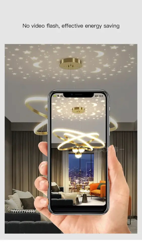 Gold-toned DecorBites™ starry sky led chandelier with interlocking rings casting star and moon patterns for living room