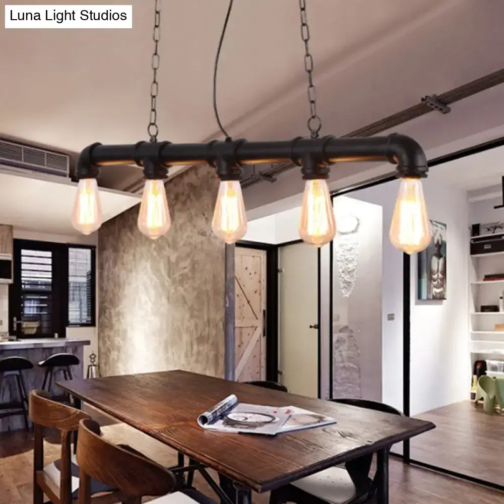 Industrial-style black pipe pendant light with four exposed led incandescent filament bulbs for dining room use